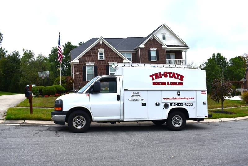 Tri-State service van parked in front of brick house